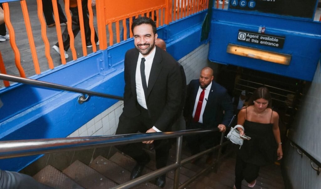 new york zohran mamdani unique style jumps into the pool in a suit and tie